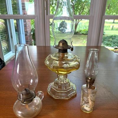 Set of three clear oil lamps