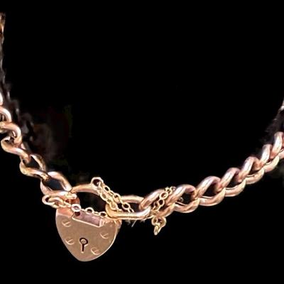 Gold curb bracelet with heart shaped padlock clasp