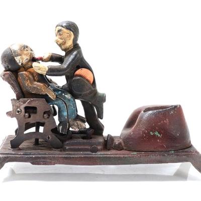 Sale Photo Thumbnail #486: Lot 486 cast iron mechanical bank dentist