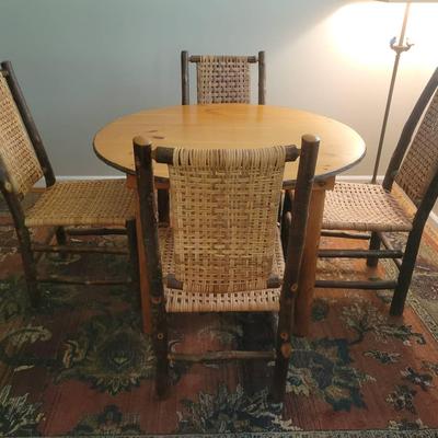 Round Wood Dining Table with Four Woven Hickory Chairs