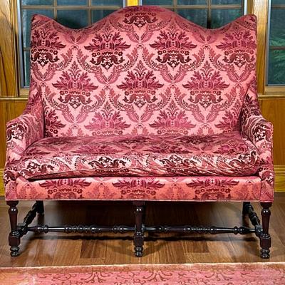 Damask Settee/Loveseat | Tall curved back loveseat in tones of red/cranberry. Dark carved wood stretchers. Cushion is attached by clips....