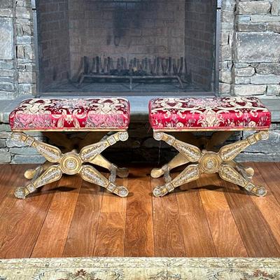 Pair Casa Stradivari X-Form Carved Wood Benches | Or stools, with textured red upholstered cushioned seats and X-form base with foliate...