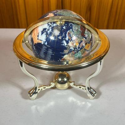 Table Top Globe | Black globe spins and tilts. Stand is gold colored plastic. - h. 9 x dia. 9 in
