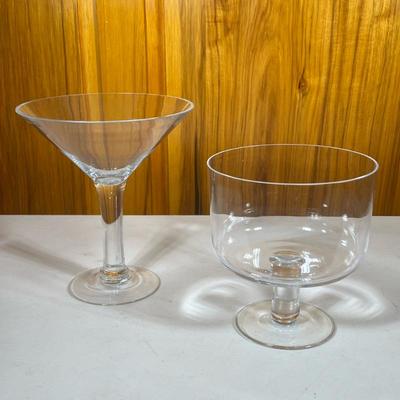 (2pc) Glass Compotes | Deep, round elevated bowl and large champagne glass shape display dish looks to be handblown. - h. 10 x dia. 9 in...