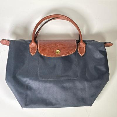 Small Longchamp Le Pliage Top Handle Tote | Grey with brown leather handles. Including zip closure under snap flap, leather trim, inside...