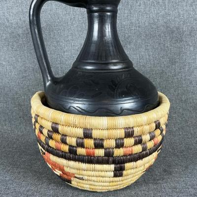 Black Pottery Jug In A Woven Basket