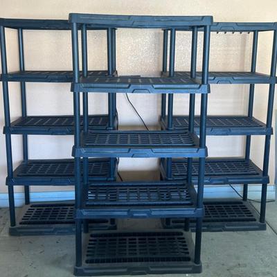Three 70” Black Plastic Shelving Units