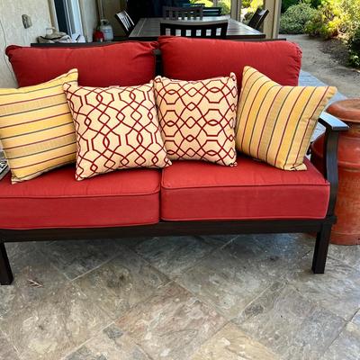 Outdoor Loveseat with Red Cushions & Decorative Pillows
