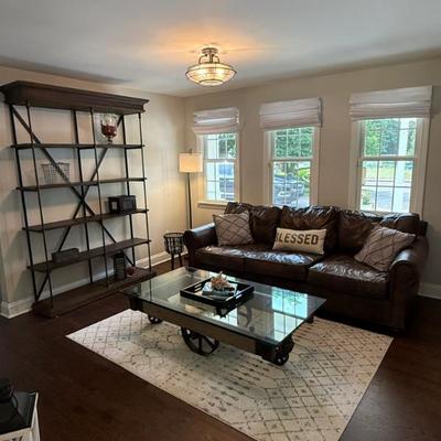 The den features furnishings from Restoration Hardware and Pottery Barn.