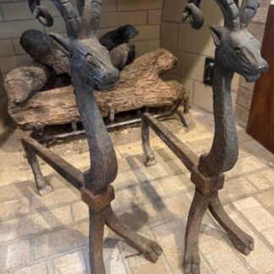 A pair of ram wrought iron andirons