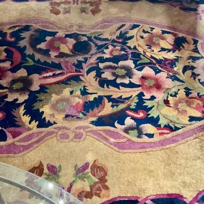 Large Chinese carpet in living room, distressed condition 