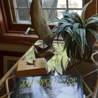 Sailboat on stone, artificial trees and plants throughout the sale. 