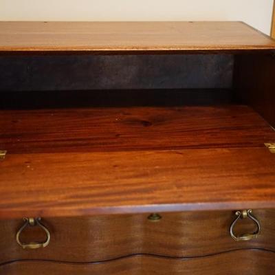 This is a flame mahogany music cabinet with drop down top and drawers to store anything of ephrema. 