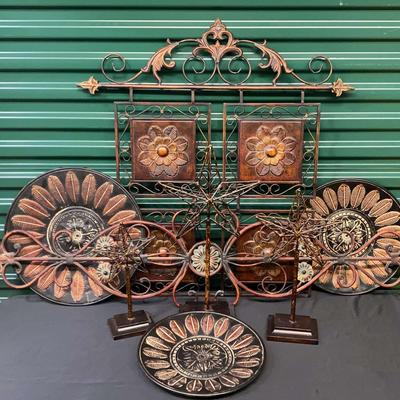 Copper-Toned Wall Décor Featuring Wall Plates, Scrollwork, And Floral Accents