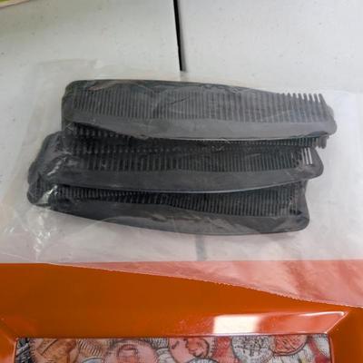 A bundle of clean black plastic combs. Ideal for dramatic play (hair salon), classroom hygiene, or sensory activities.