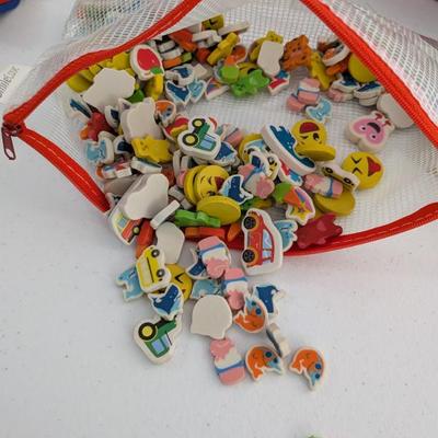  A large collection of small, colorful erasers or foam figurines in assorted shapes (emojis, cars, food, animals, etc.). Fantastic for...