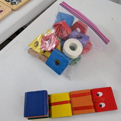 A colorful collection of durable wooden blocks in various shapes and sizes, with some featuring holes. Excellent for stacking, sorting,...