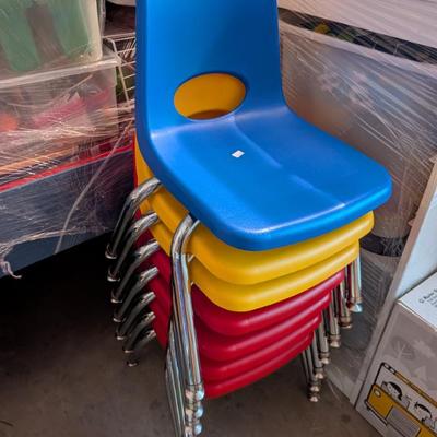  A collection of sturdy, brightly colored (red, yellow, blue, etc.) child-sized chairs, built for the rigors of a classroom setting....