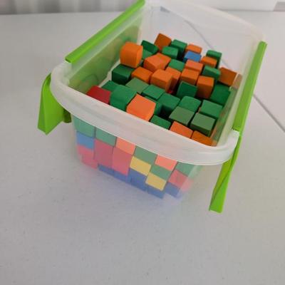 Large Set of Colorful Foam Building Blocks in Storage Container: A substantial collection of vibrant, uniformly small sized building...