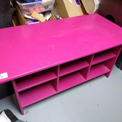 Low pink table with cubbies