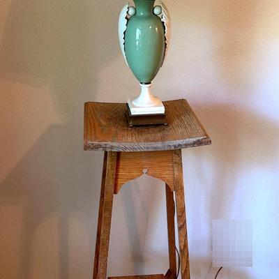 Antique wooden stool and a seafoam green glass lamp with a brass base