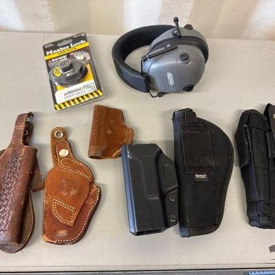 Sale Photo Thumbnail #239: #5502 • 6 Gun Holsters, Master Lock Gun Lock, Champion Range and Target Earmuffs
