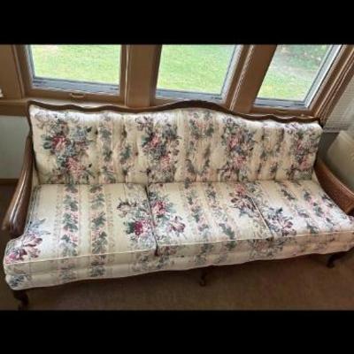 Floral couch with carved wood and rattan