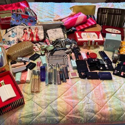 A Large Assortment Of Estee Lauder And Mary Kay Cosmetics With Bags