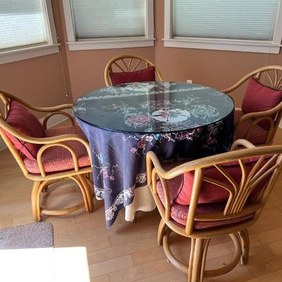 Rattan dining table and 4 swivel chairs
