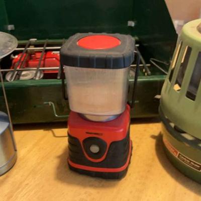 Coleman stove and heater two lanterns and three chairs