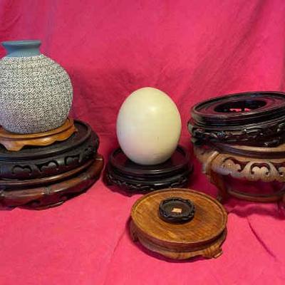 Wooden platforms an egg and a vase