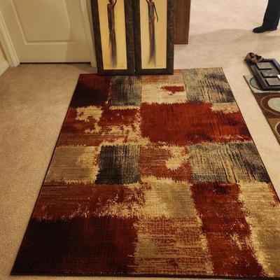 Deep Red And Tan Area Rug With Prints