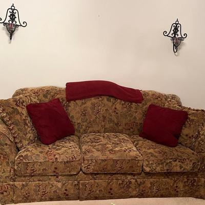 Floral Upholstered Pull Out Couch With Decorative Candle Holders