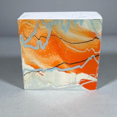 Signed Lacquered Abstract Art Block | Signed lacquered art on wood panel with bold orange, cream, and gray marbled design, presented as a...