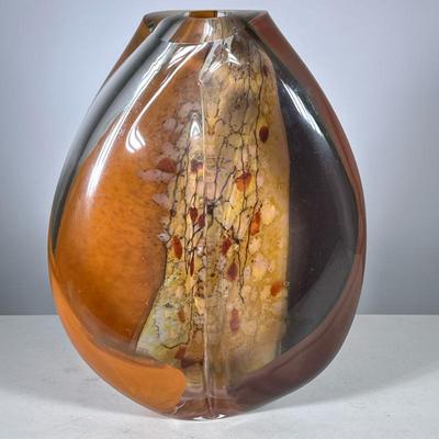STUDIO ART GLASS VASE IN AMBER, SIGNED | Colorful twisted art glass vase, of sculptural oval form with layered amber, brown, and ochre...