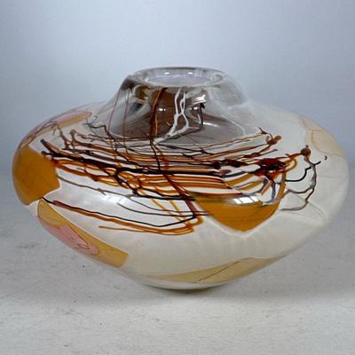 SIGNED STUDIO ART GLASS VASE | Handblown thick art glass vase of wide form with a narrowed neck, having flowing trails of brown and black...