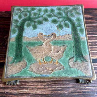 Circa 1917 molded Grueby Pottery Tile set in a bronze trivet by Tiffany Glass Company (Louis Comfort Tiffany)
