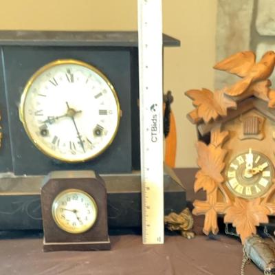 Three antique clocks featuring a German Made cuckoo clock