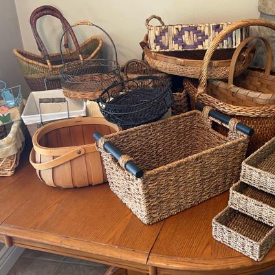 Large group of baskets various sizes many are wicker, but others are woven and some are made of  metal
