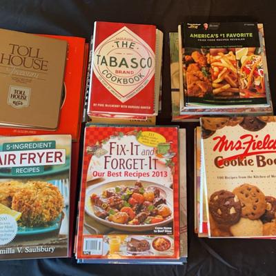 A variety of cookbooks featuring air fryer recipes, Mrs. Fields cookie book and the Tabasco  brand