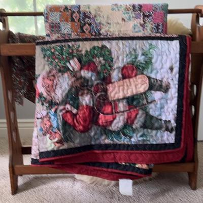 Quilt Rack With Two Quilts Featuring One Holiday Quilt, And A Sheepskin Rug
