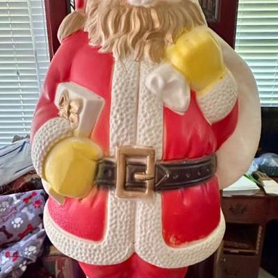 Vintage blow mold Santa. It does have some issues.