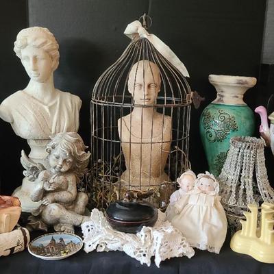 Home Decor Featuring Resin Busts, Bird Cage, and Decorative Accents