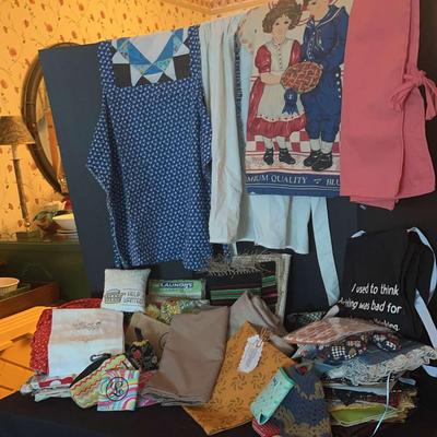 Colorful Assortment of Aprons, Table Linens, and Kitchen Accessories