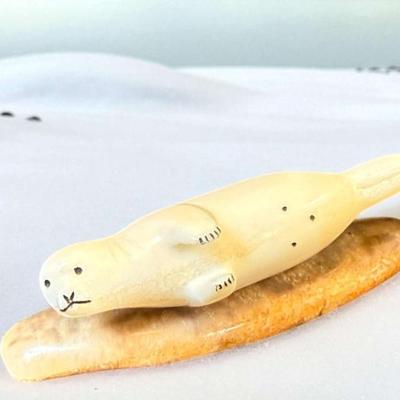 Inuit carved seal figure with scrimshaw