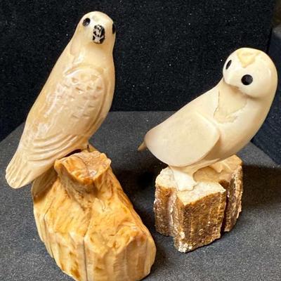 Two inuit carved birds on a perch figurines