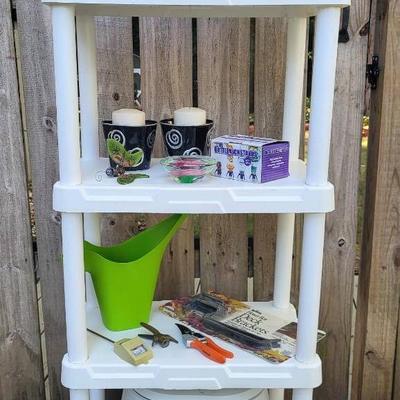 White Plastic 4-Tier Shelf with Gardening Items