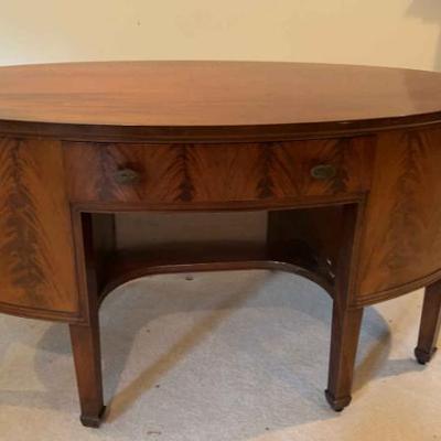 Antique flame mahogany double sided oval sideboard desk