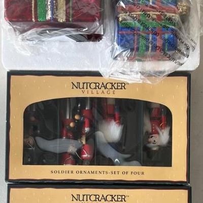 (2) Sets Of Nutcracker Village Soldier Ornaments, And (3) Illuminated Christmas Presents