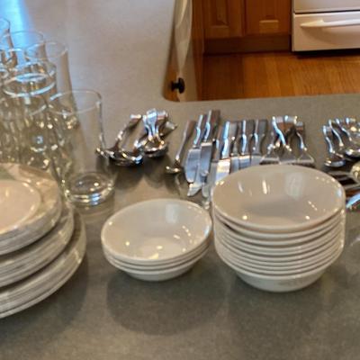 A Variety Of Kitchen Items including Corelle Dishes, Glasses, & Silverware